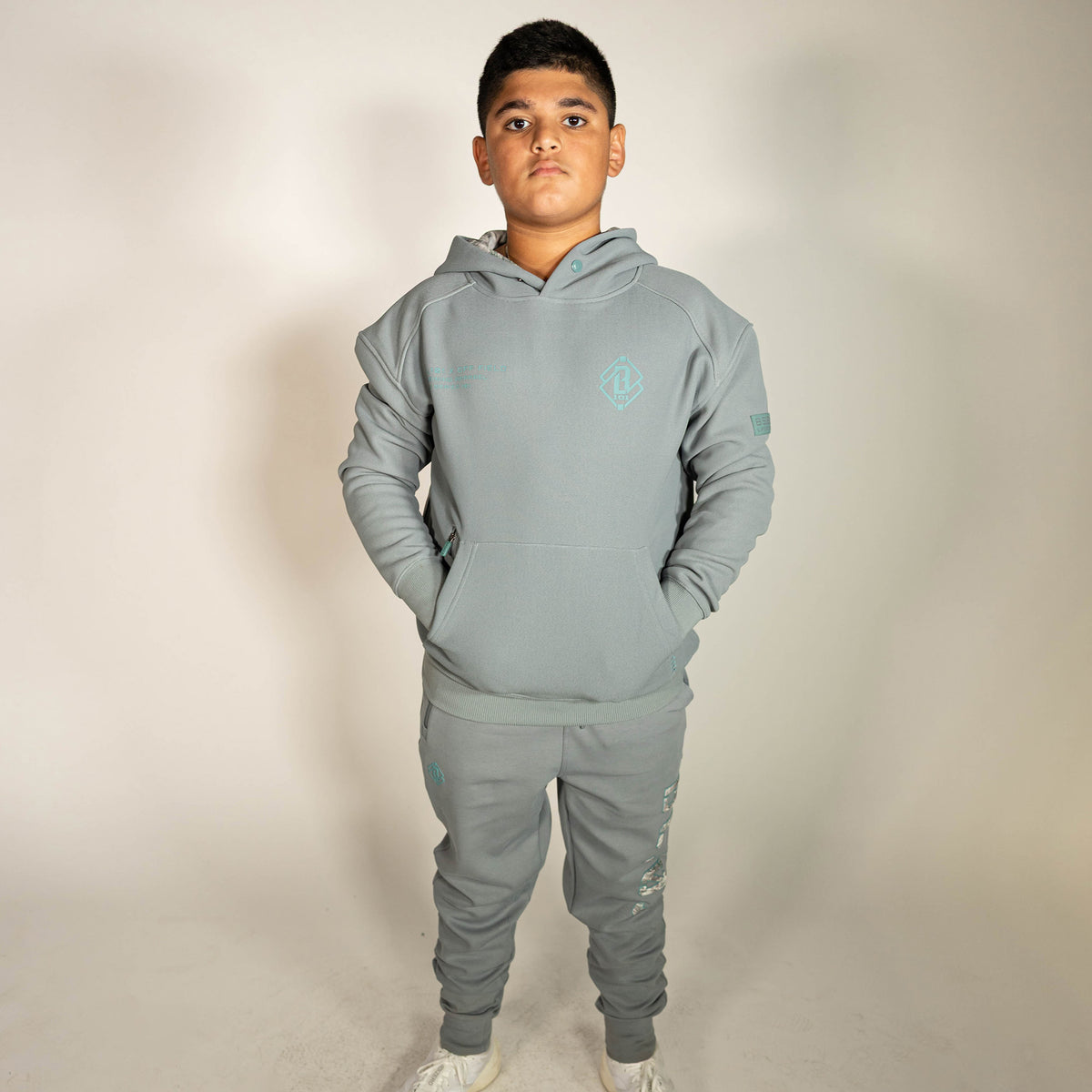 Youth model wearing gray Realtree Aspect Off-Field Waffle Performance Camo youth hoodie