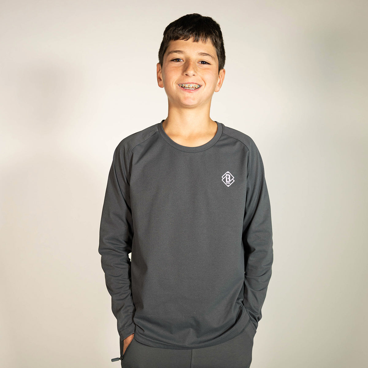 Youth model wearing gray and lilac Diamond Tech youth long sleeve
