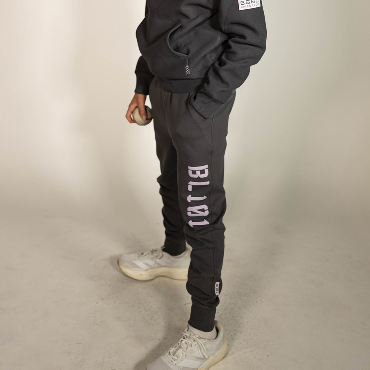 Youth model wearing gray and lilac Diamond Relaxed Fit youth joggers