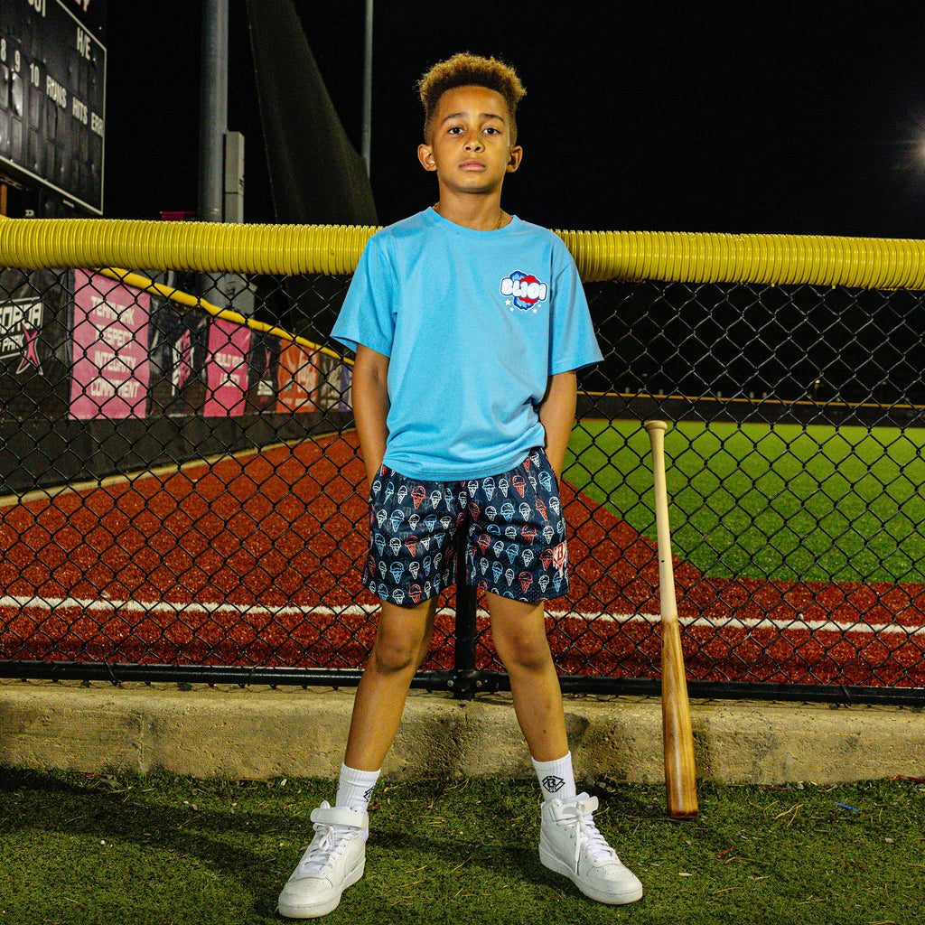 Youth model wearing red, white & blue Scoops Ice Cream youth shorts