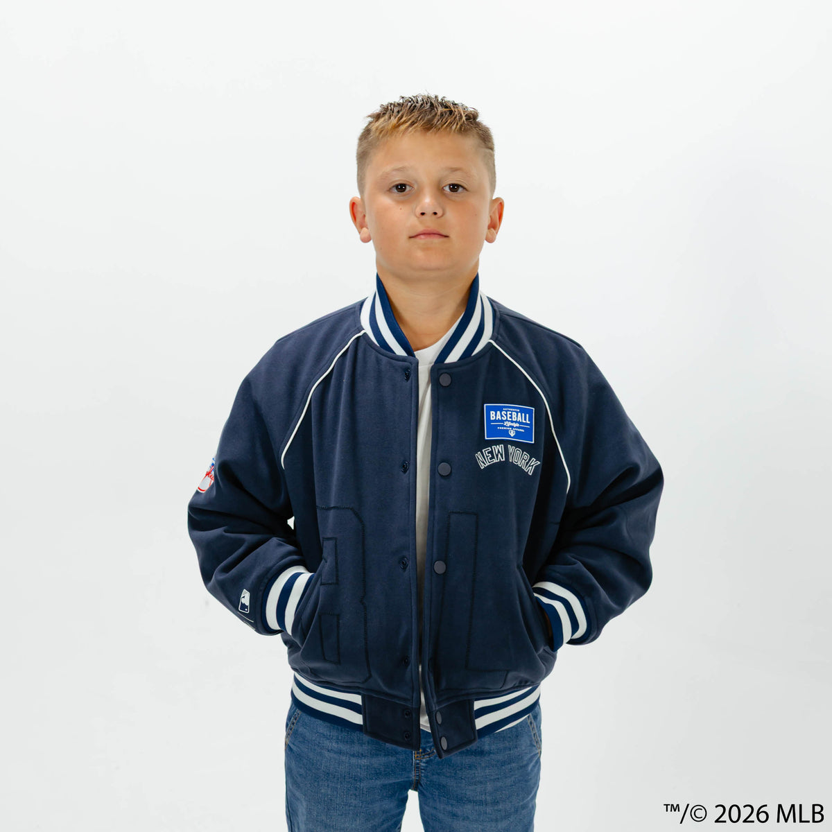 Youth model wearing navy New York Yankees Stadium youth bomber jacket