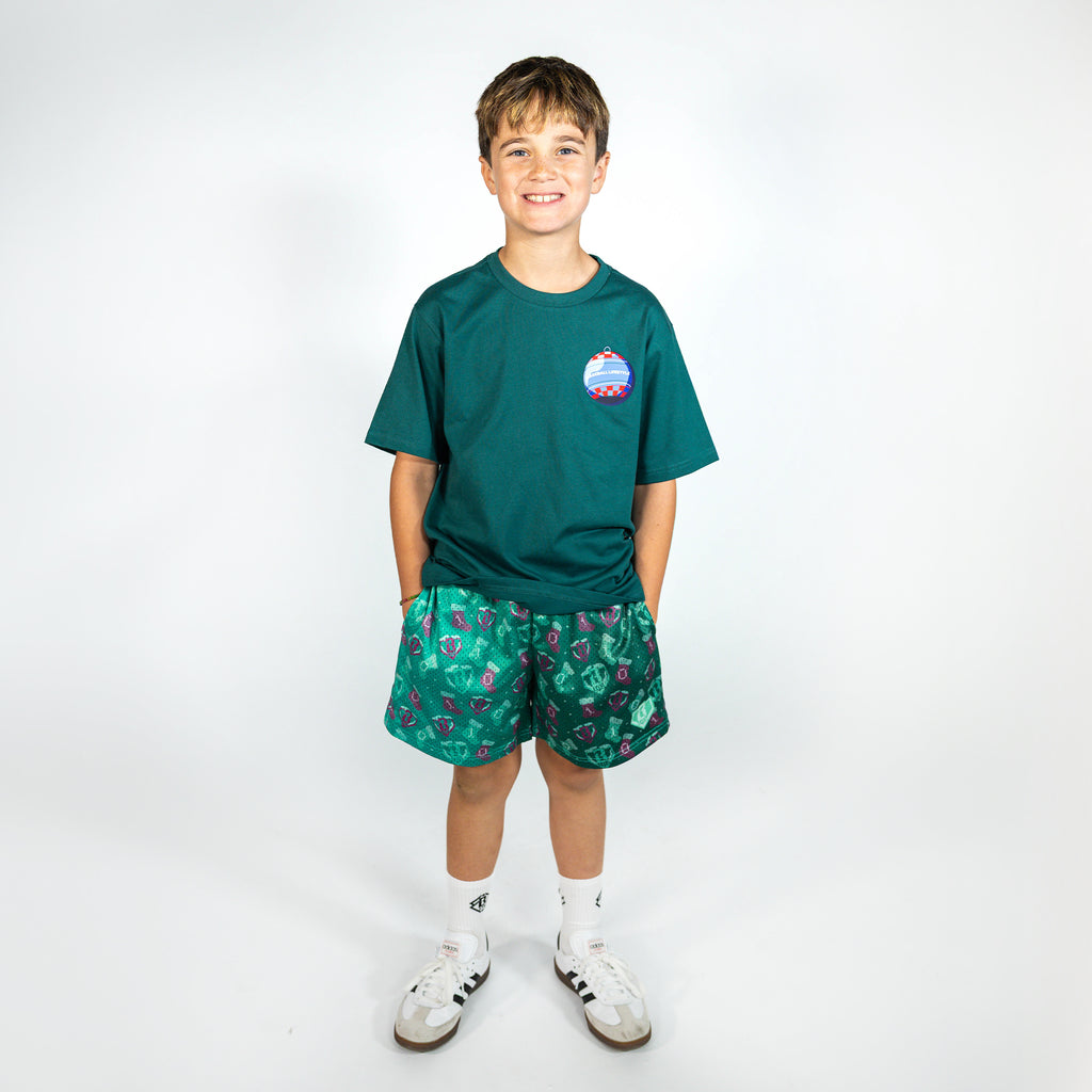 Youth model wearing green Stitched For The SZN youth shorts