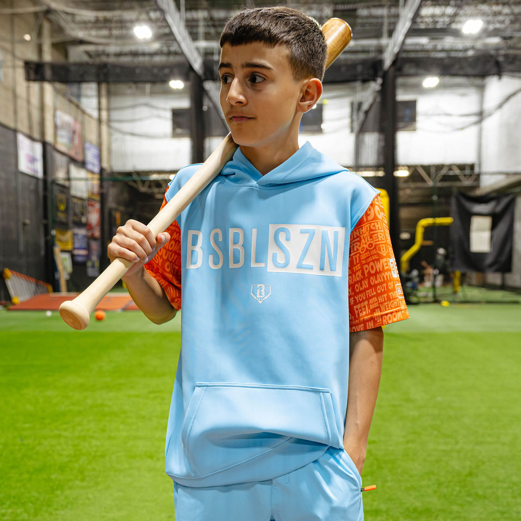 Youth model wearing blue youth short sleeve hoodie with "BSBL-SZN V3 Short Sleeve Youth" design
