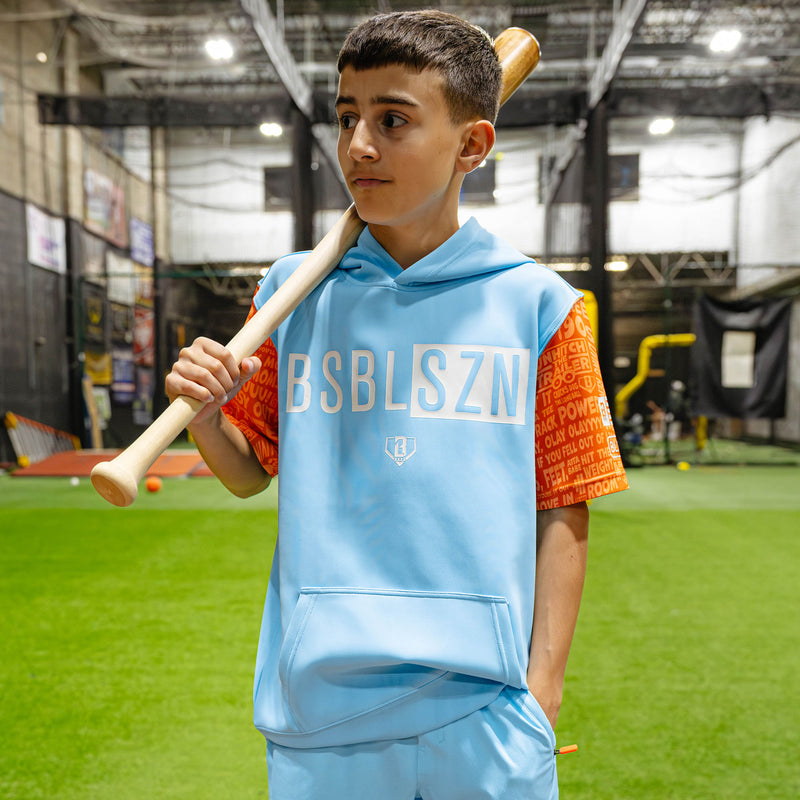 Youth model wearing blue youth short sleeve hoodie with "BSBL-SZN V3 Short Sleeve Youth" design