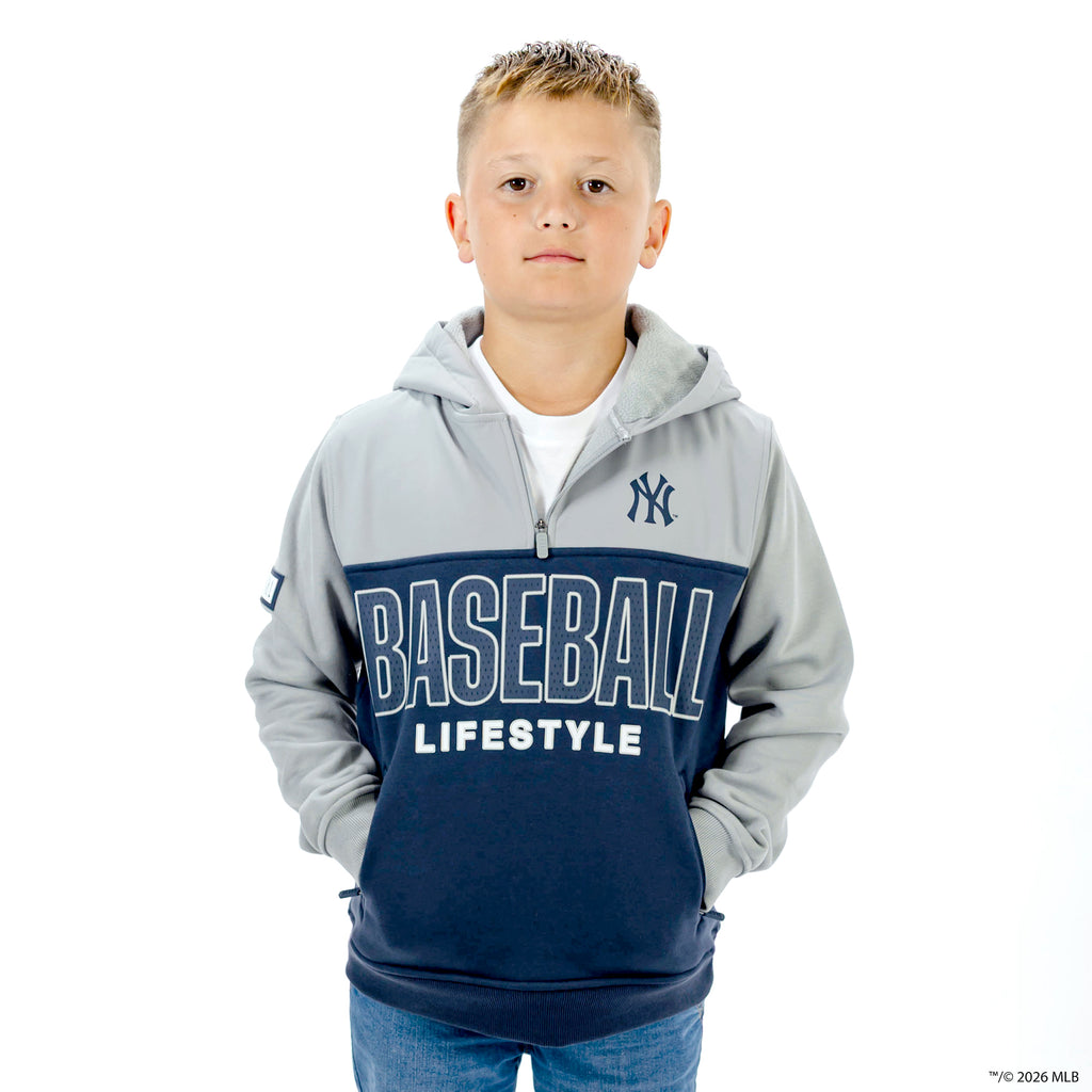 Youth model wearing navy New York Yankees Color Block youth quarter zip