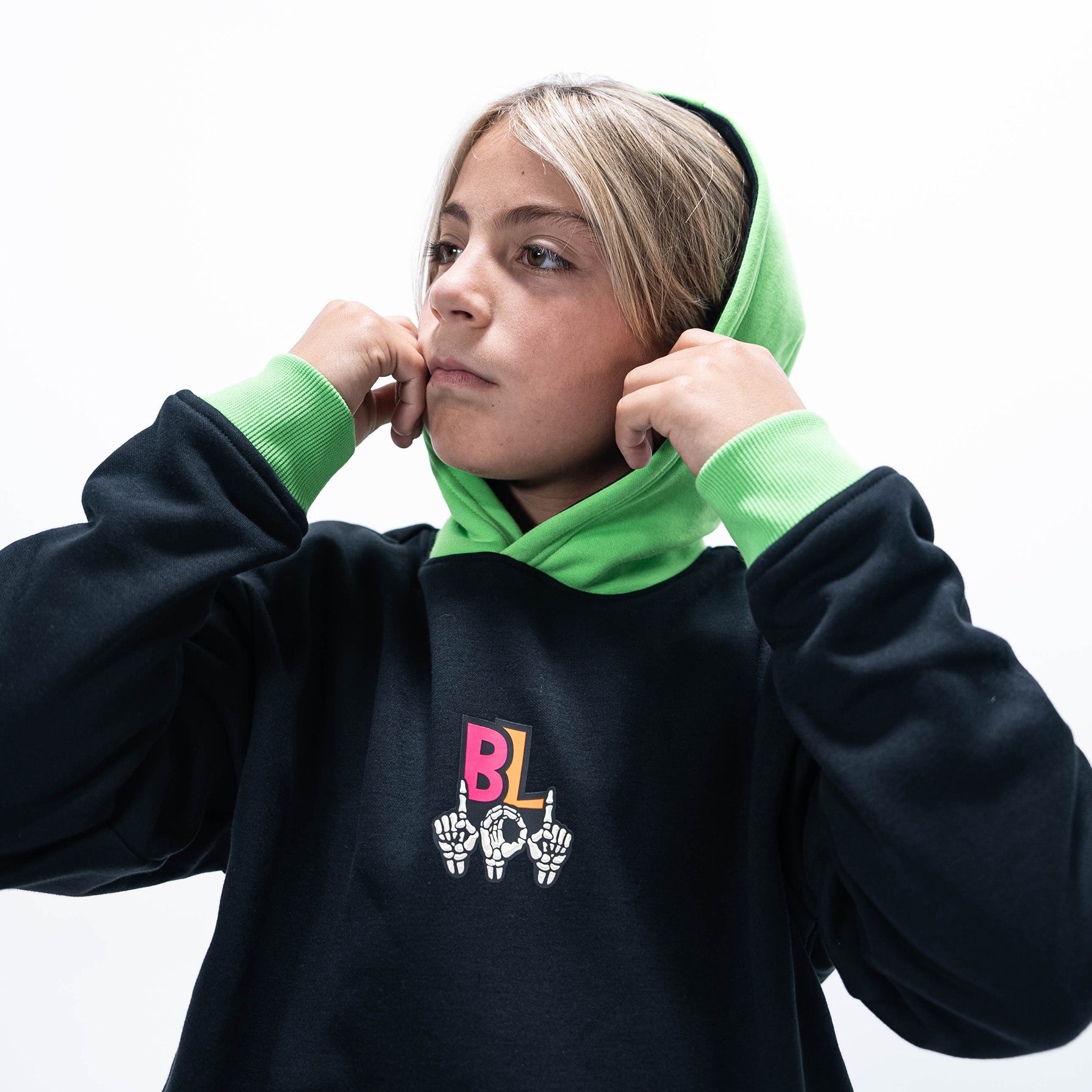 Youth model wearing black youth hoodie with "101 Skeleton" design