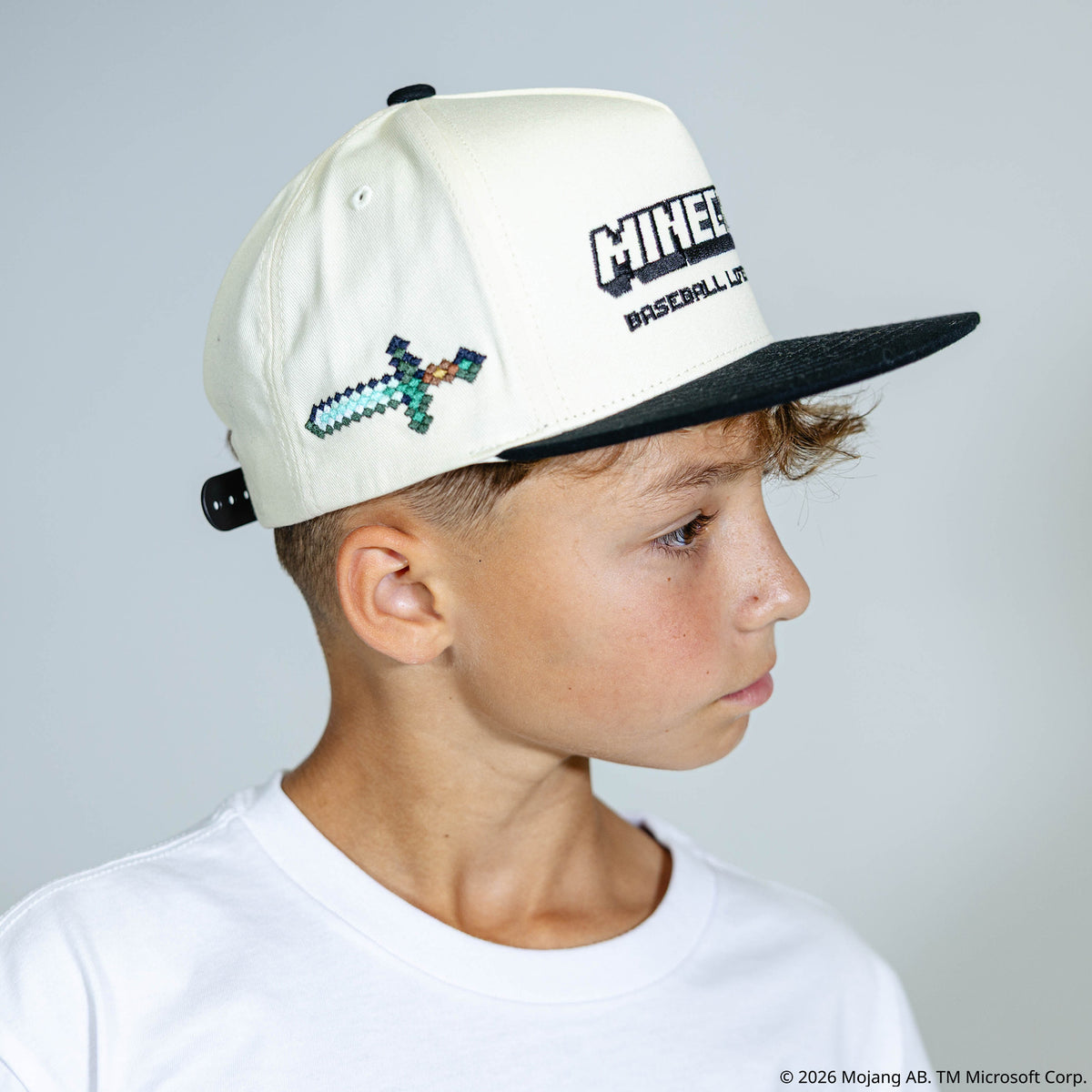 Adult model wearing black and white hat with "BL101 x Minecraft Sword" design
