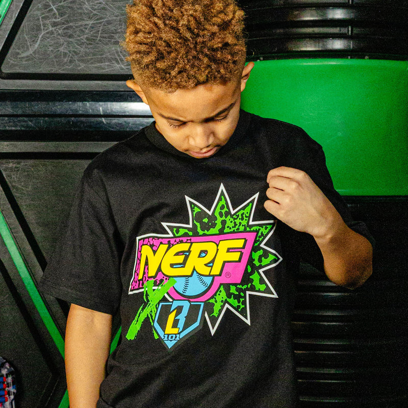 Child wearing a black t-shirt with a colorful 'NERF X BL101' logo in front of a green and black background.