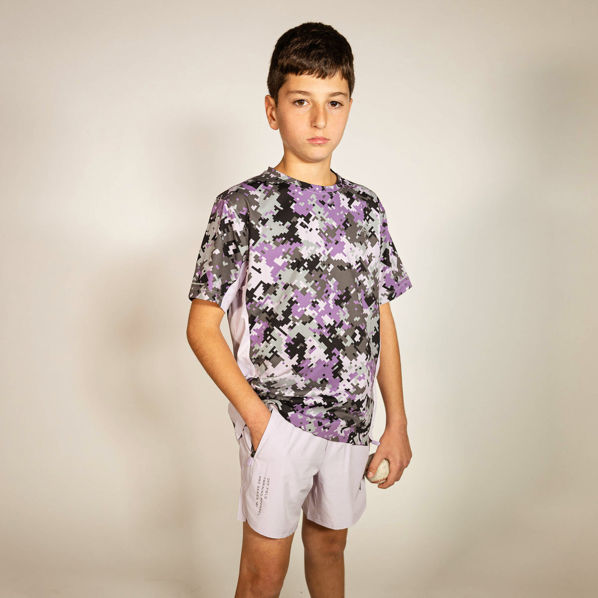 Youth model wearing multi-color Digi Camo Diamond Tech youth vented tee