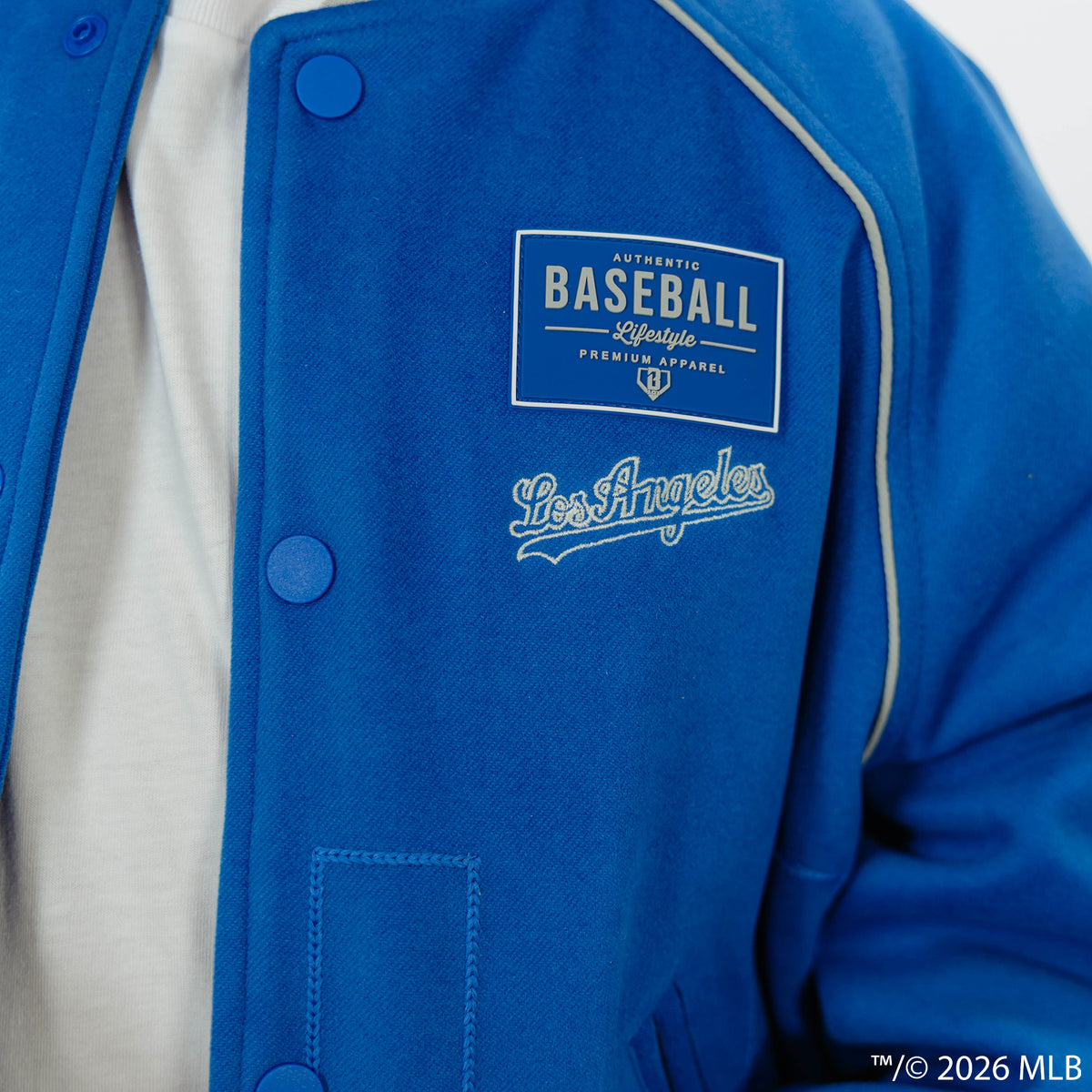 Youth model wearing blue Los Angeles Dodgers Stadium youth bomber jacket