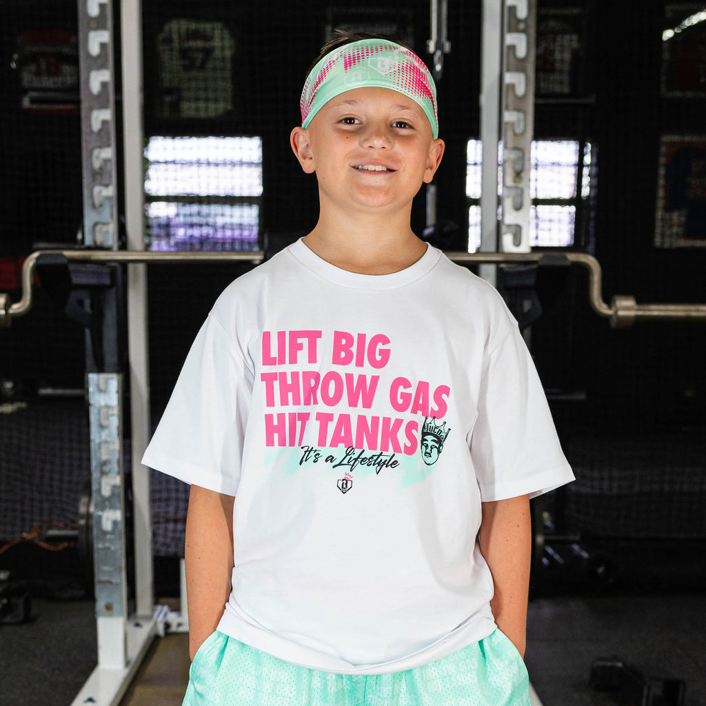 Youth model wearing teal headband with "Hit Tanks" design