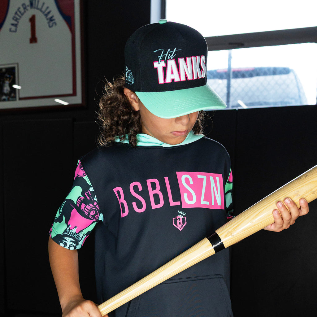 Youth model wearing black hat with "Hit Tanks" design