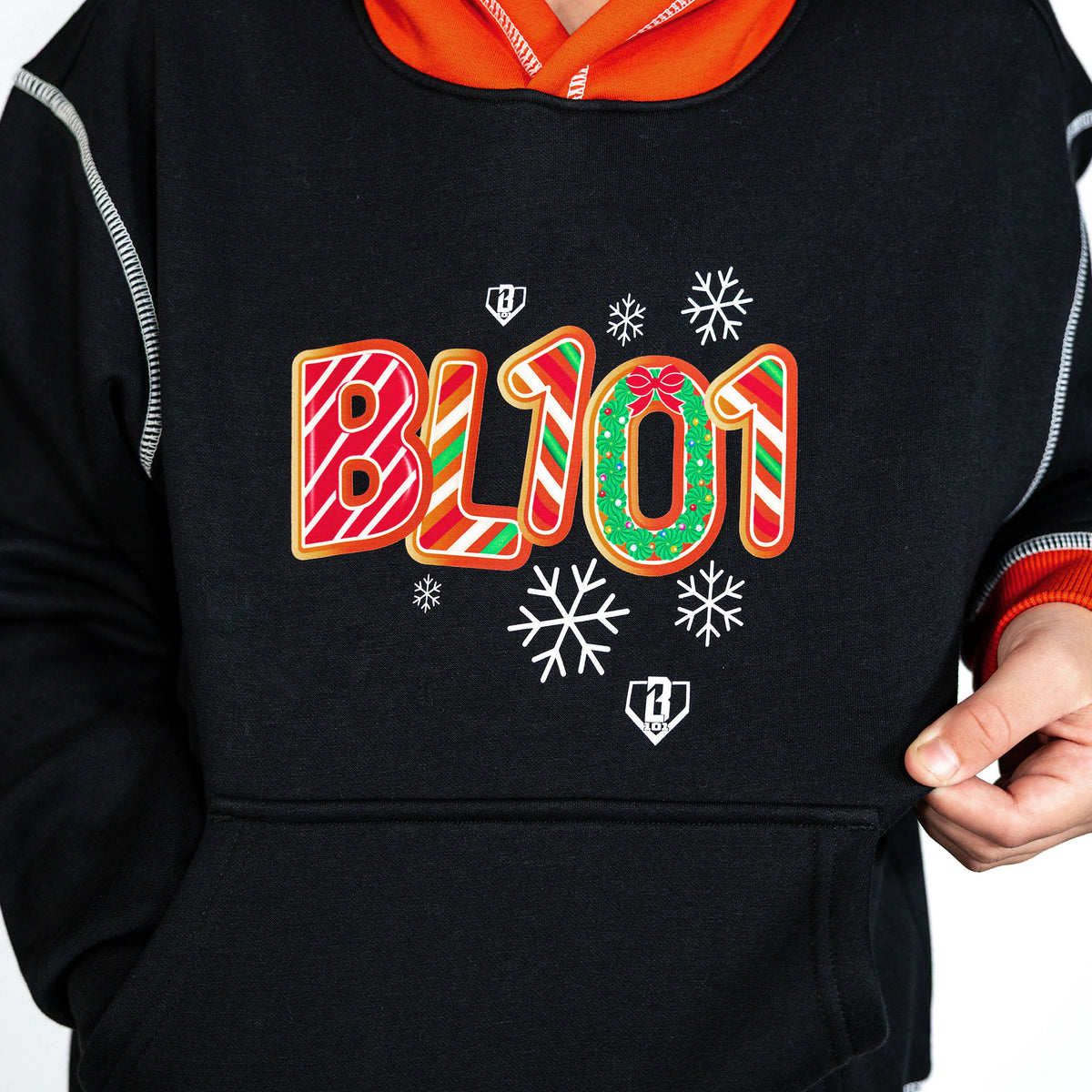 Youth model wearing black youth hoodie with "Holiday Cookie" design
