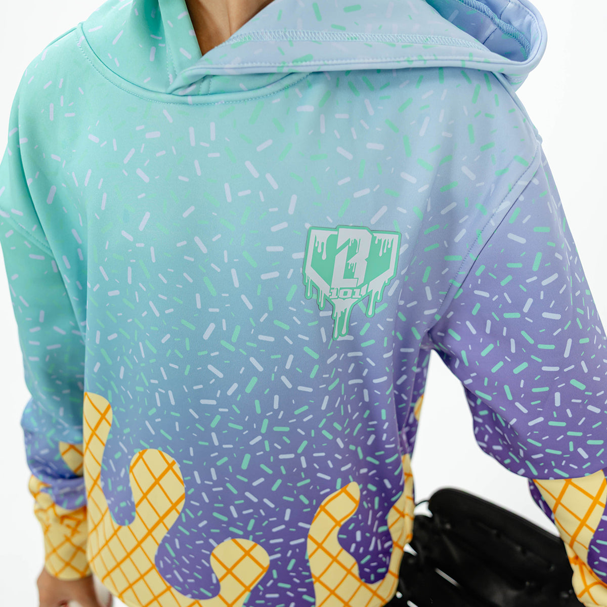 Youth model wearing multi-color Ice Cream Galaxy Grape youth hoodie with "Ice Cream" design