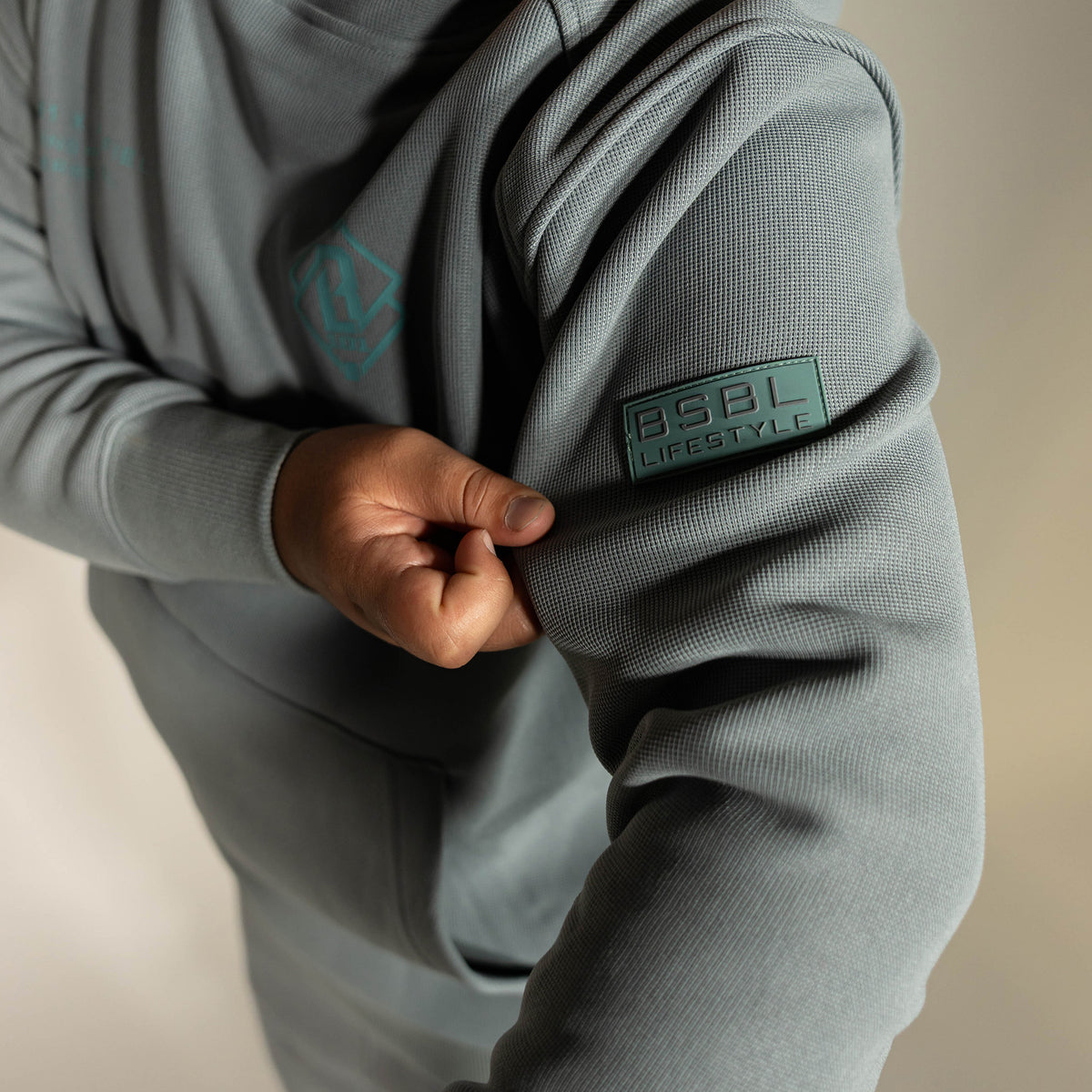 Youth model wearing gray Realtree Aspect Off-Field Waffle Performance Camo youth hoodie