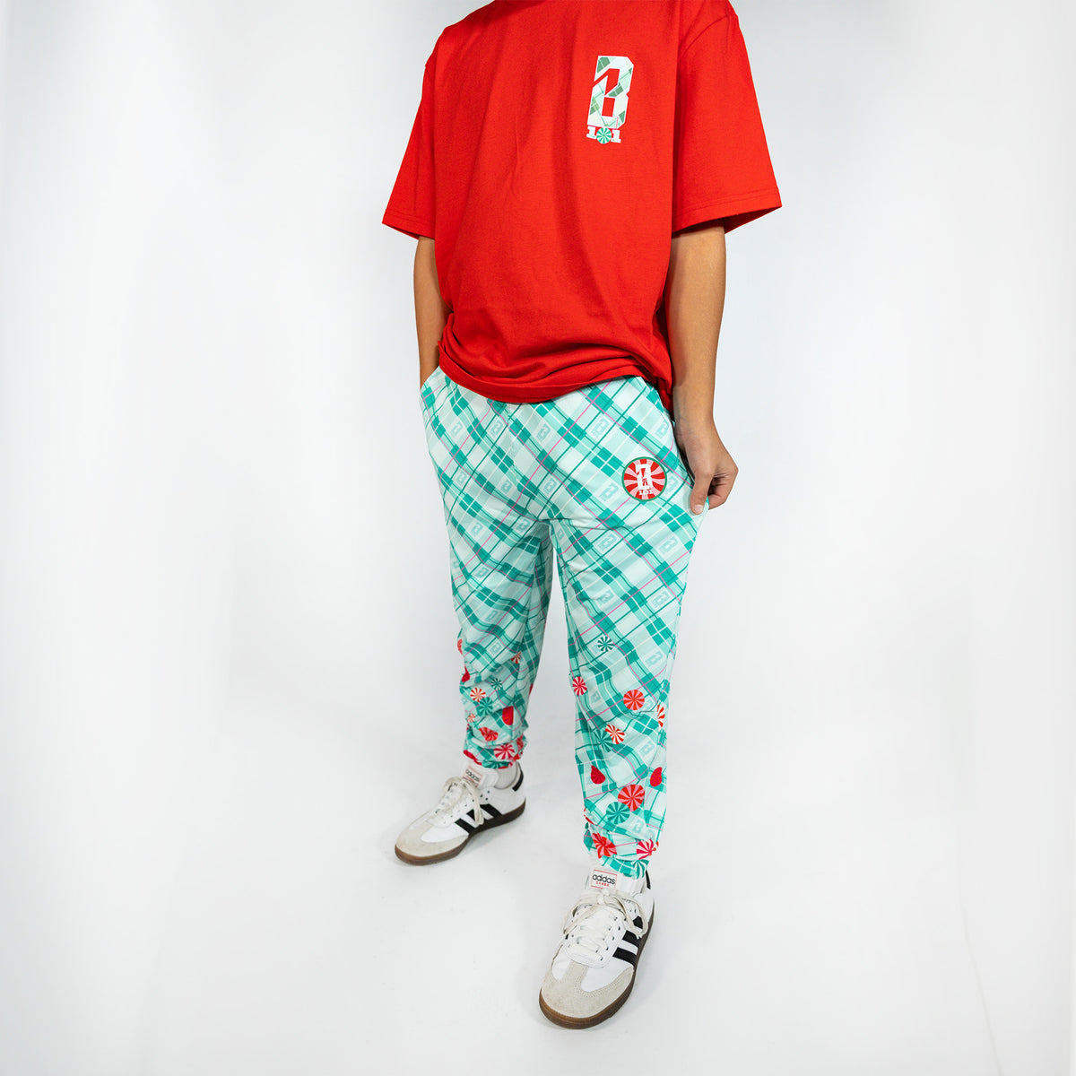 Youth model wearing multi-color youth pajama pants with "Peppermint Plaid" design