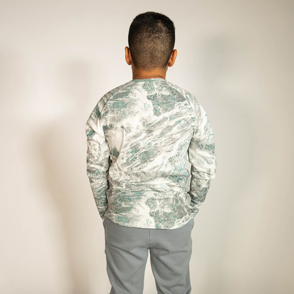Youth model wearing gray Realtree Aspect Diamond Tech Camo youth long sleeve