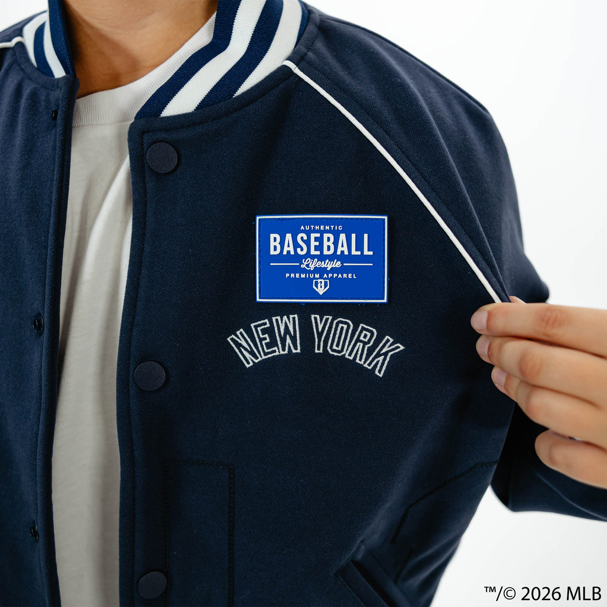 Youth model wearing navy New York Yankees Stadium youth bomber jacket