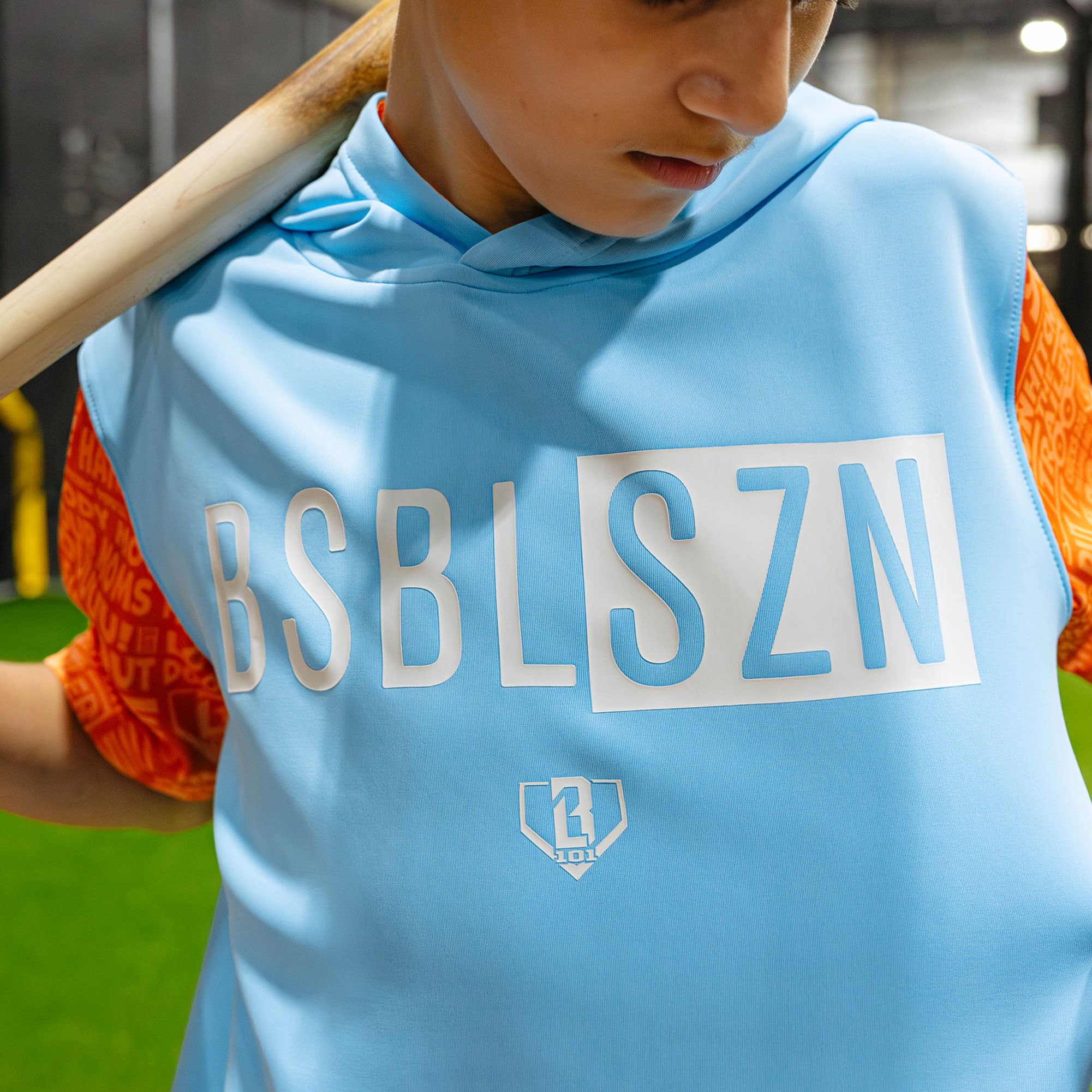 Youth model wearing blue youth short sleeve hoodie with "BSBL-SZN V3 Short Sleeve Youth" design