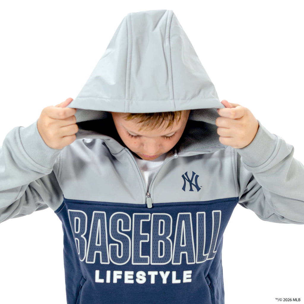 Youth model wearing navy New York Yankees Color Block youth quarter zip