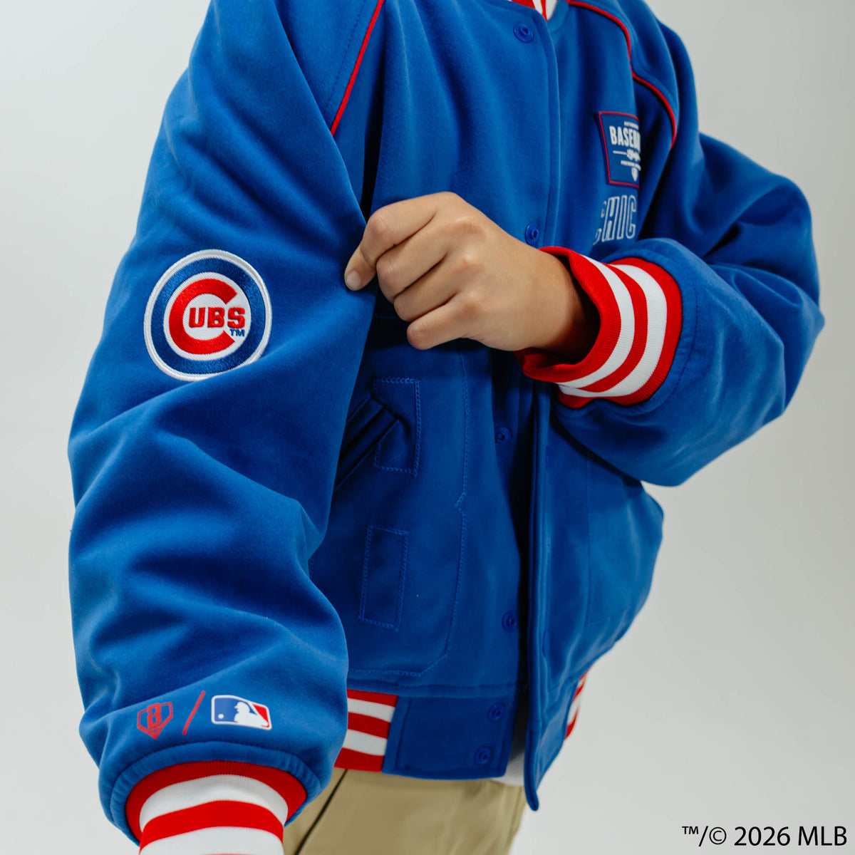 Youth model wearing blue Chicago Cubs Stadium youth bomber jacket