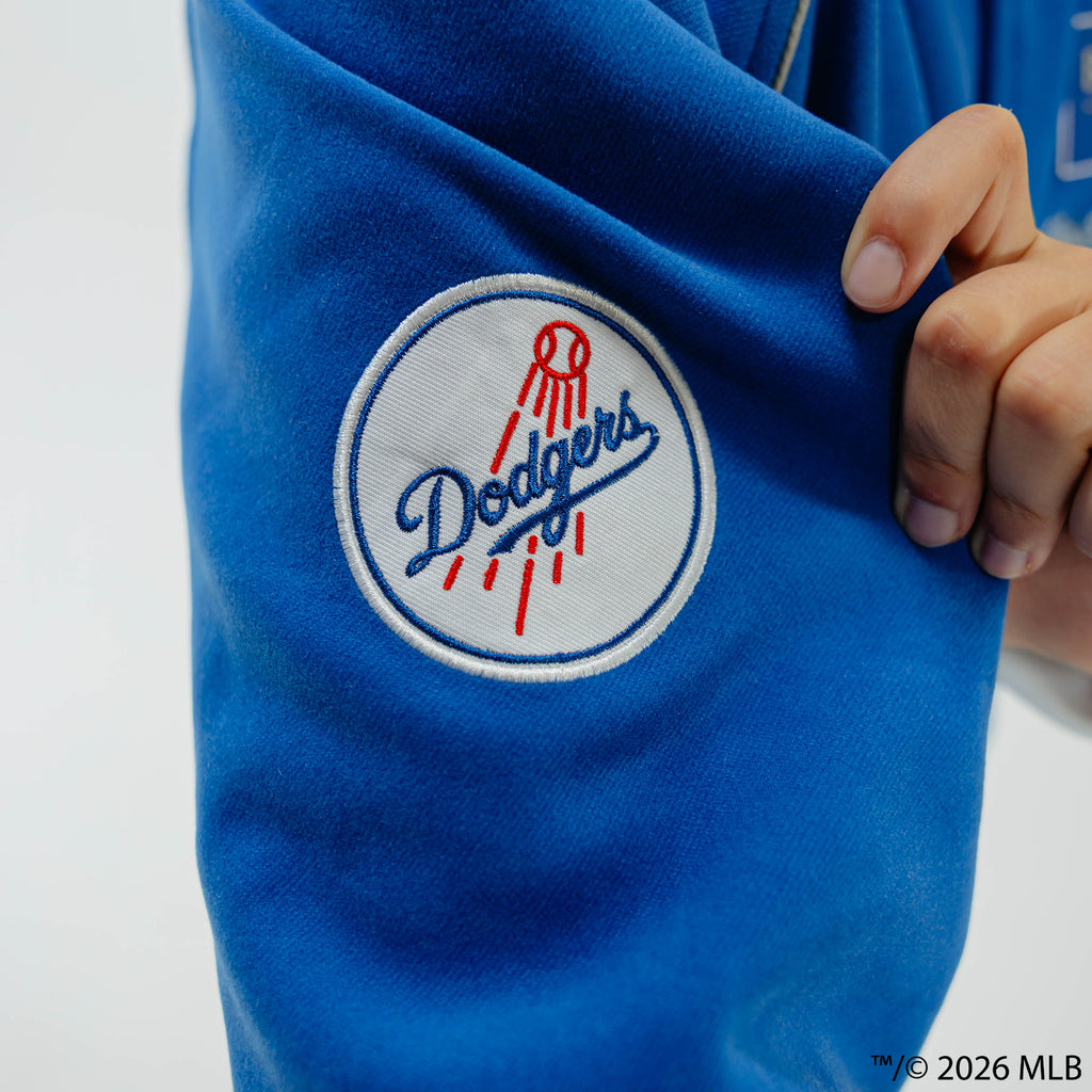 Youth model wearing blue Los Angeles Dodgers Stadium youth bomber jacket