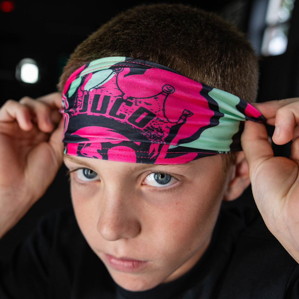 Youth model wearing black headband with "King of JUCO" design