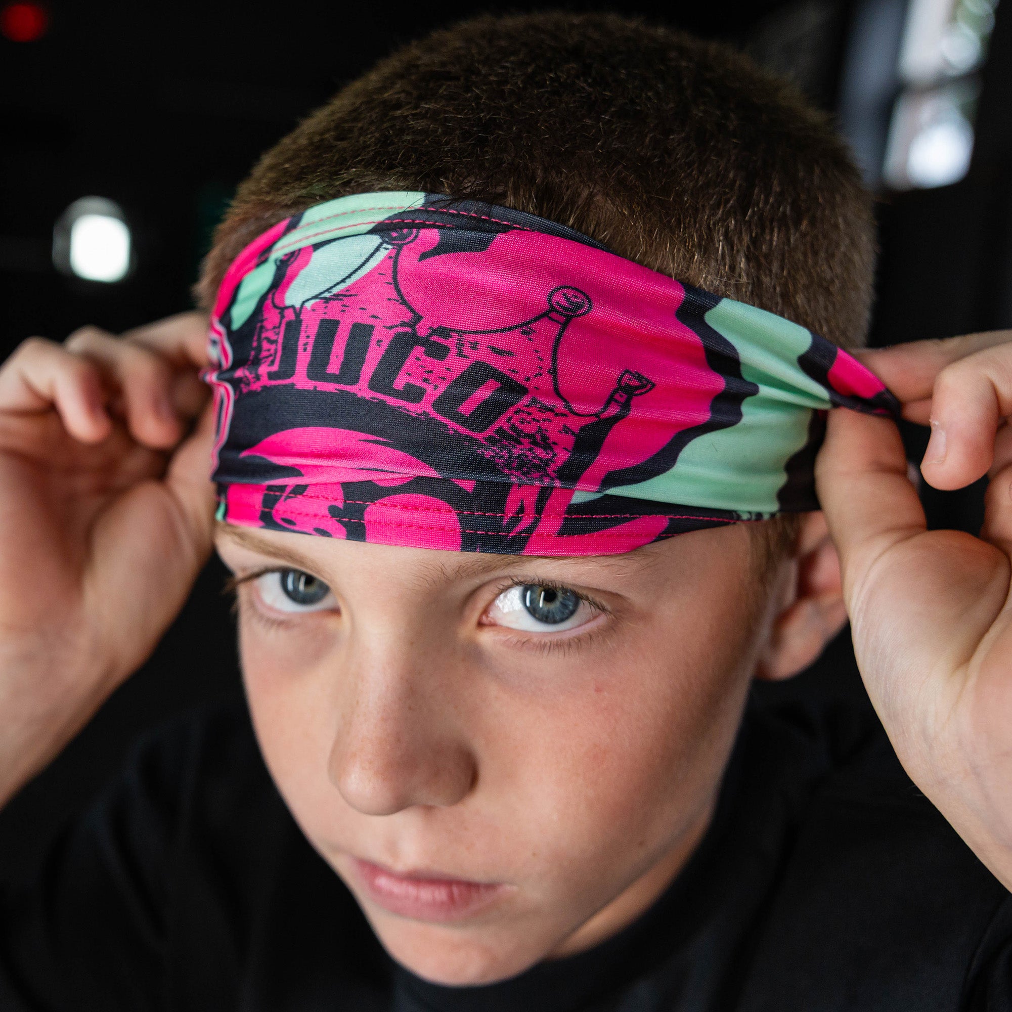 Youth model wearing black headband with "King of JUCO" design