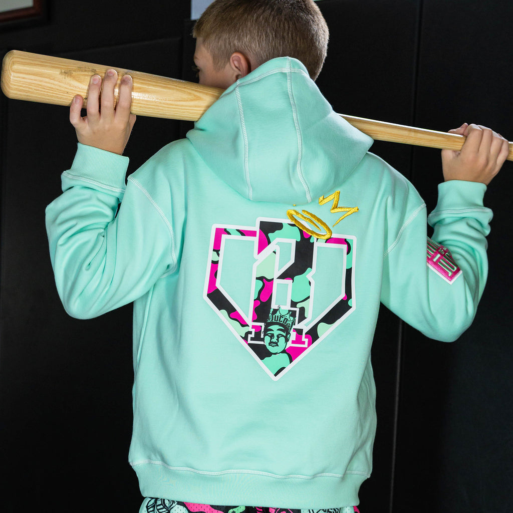 Youth model wearing teal hoodie with "King Of JUCO" design