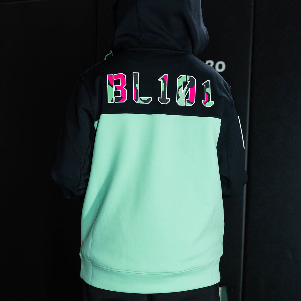 Youth model wearing teal quarter zip hoodie with "King Of JUCO" design