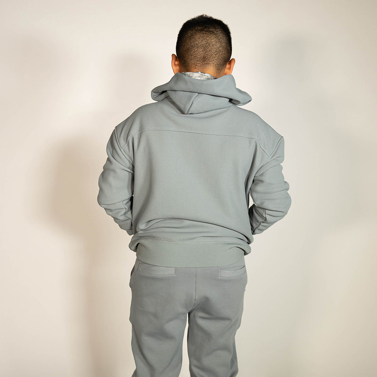 Youth model wearing gray Realtree Aspect Off-Field Waffle Performance Camo youth hoodie