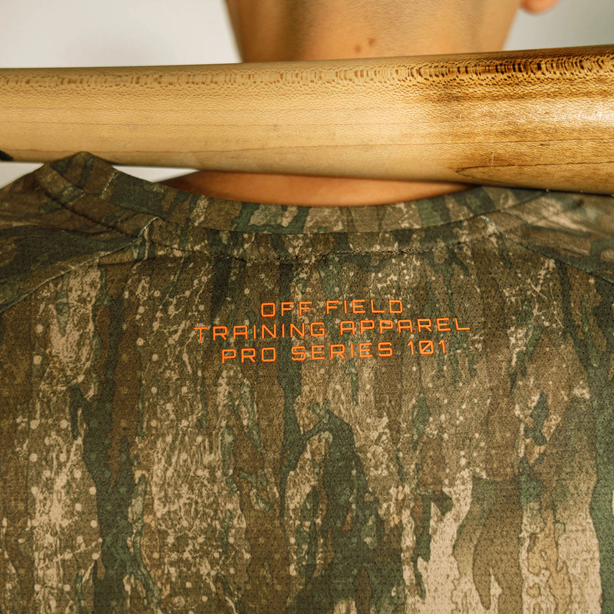 Youth model wearing multi-color Realtree Legacy Diamond Tech Camo youth long sleeve