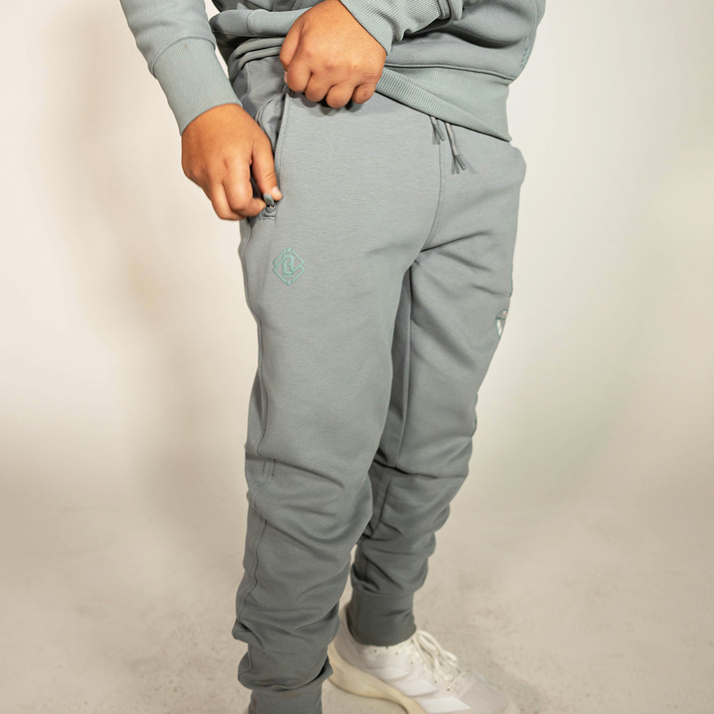 Youth model wearing gray Realtree Aspect Diamond Relaxed Fit Camo youth joggers