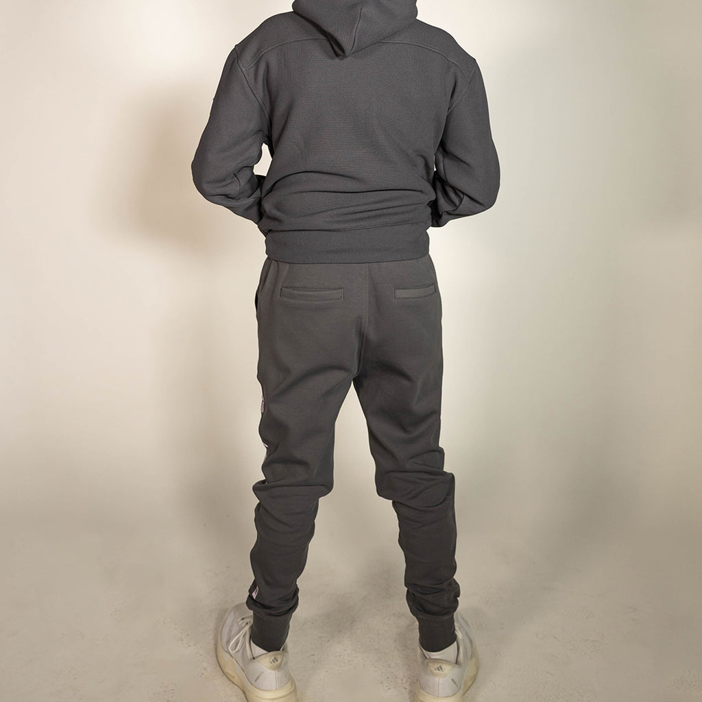 Youth model wearing gray and lilac Diamond Relaxed Fit youth joggers