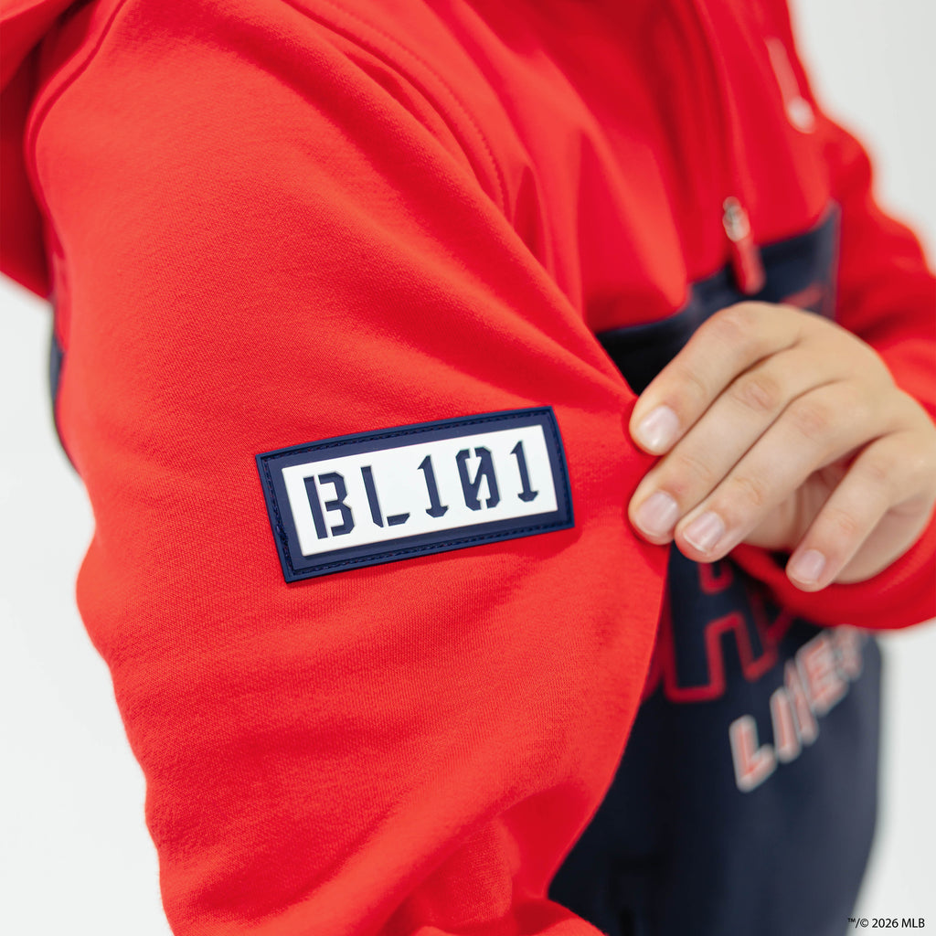 Youth model wearing red Boston Red Sox Color Block youth quarter zip