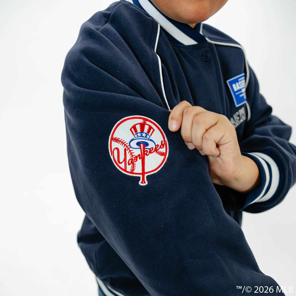Youth model wearing navy New York Yankees Stadium youth bomber jacket