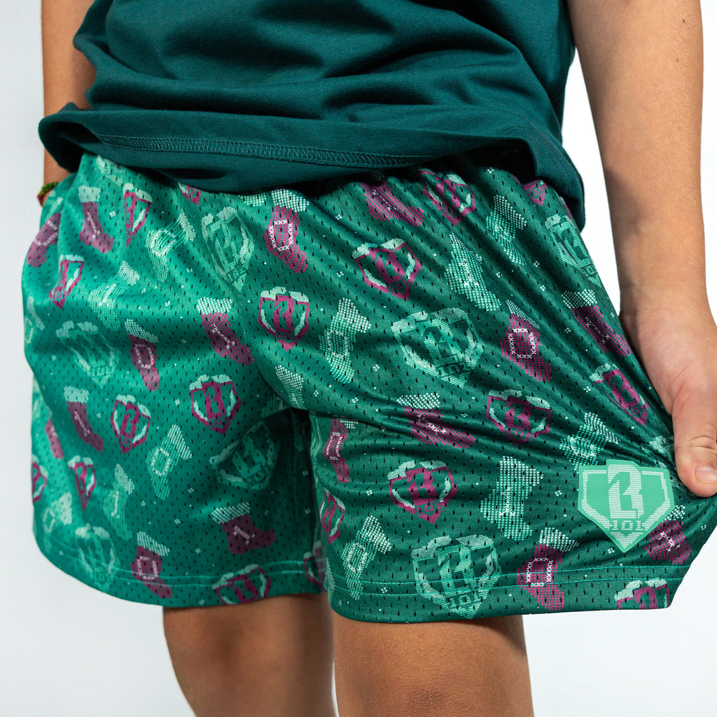Youth model wearing green Stitched For The SZN youth shorts