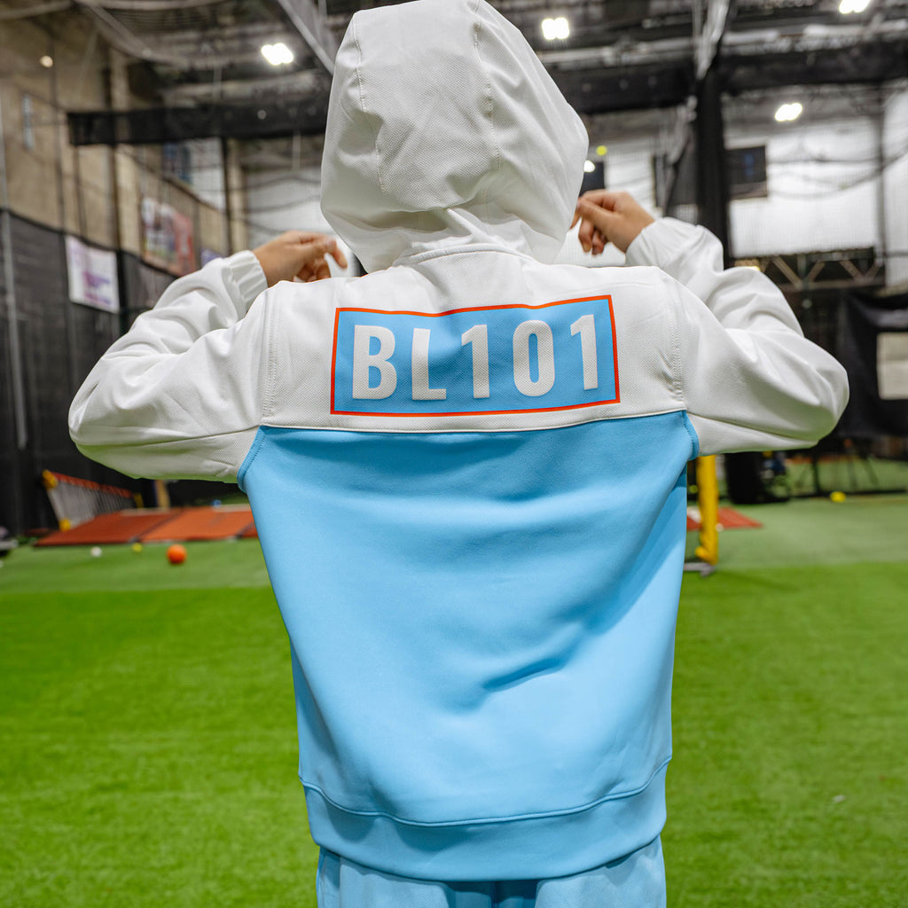 Youth model wearing multi-color youth hoodie with "UVChangeup Trash Talk Youth" design