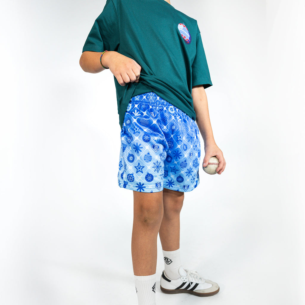 Youth model wearing blue youth shorts with "Frozen Diamond" design