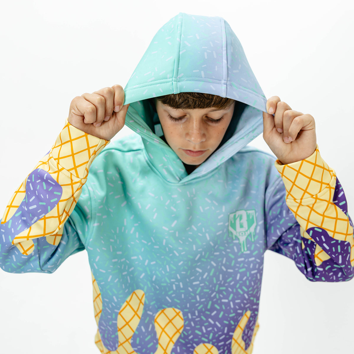 Youth model wearing multi-color Ice Cream Galaxy Grape youth hoodie with "Ice Cream" design