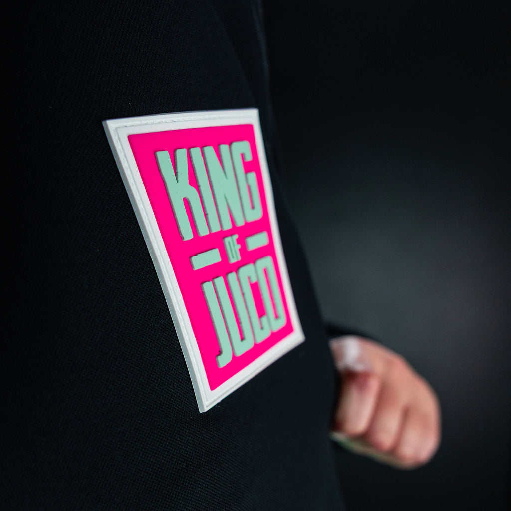 Youth model wearing teal quarter zip hoodie with "King Of JUCO" design