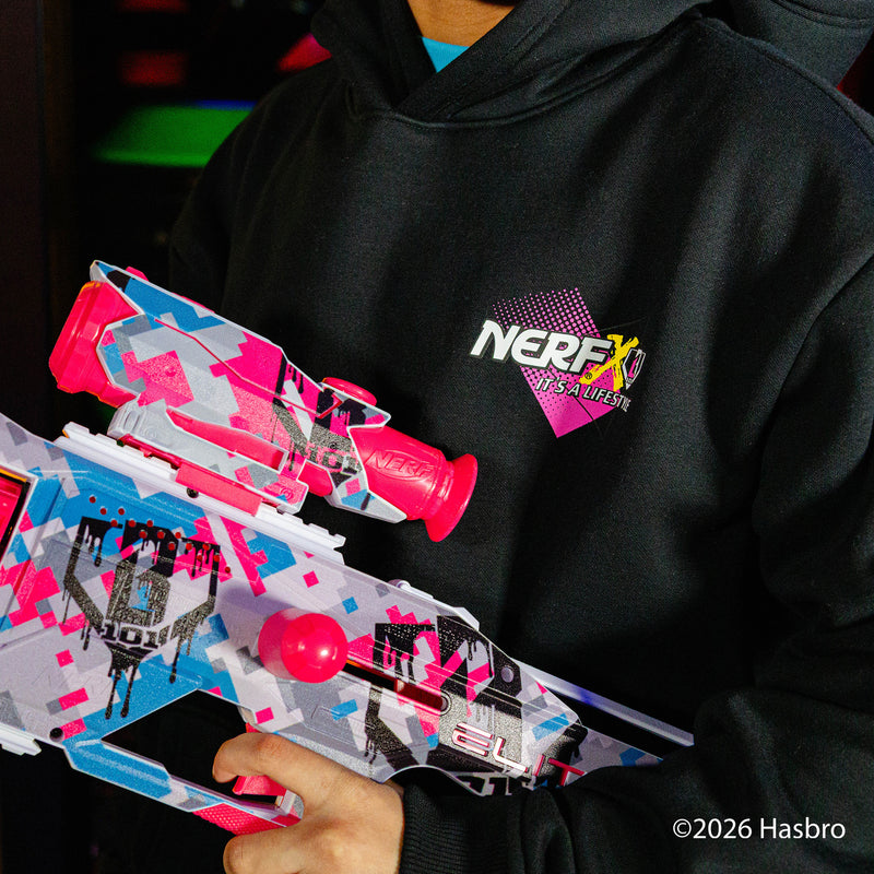 Person wearing a black hoodie with a Nerf X BL101 logo, holding two colorful nerf guns.