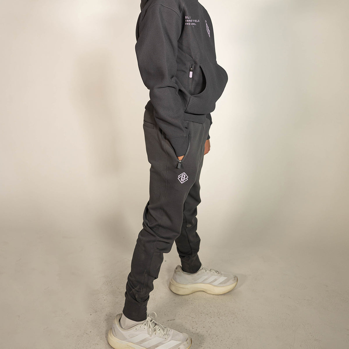 Youth model wearing gray and lilac Diamond Relaxed Fit youth joggers