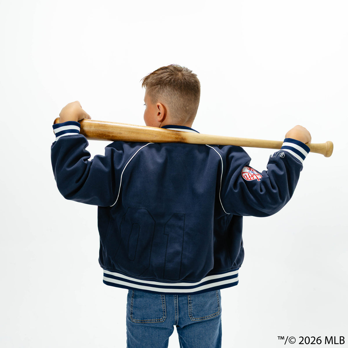 Youth model wearing navy New York Yankees Stadium youth bomber jacket