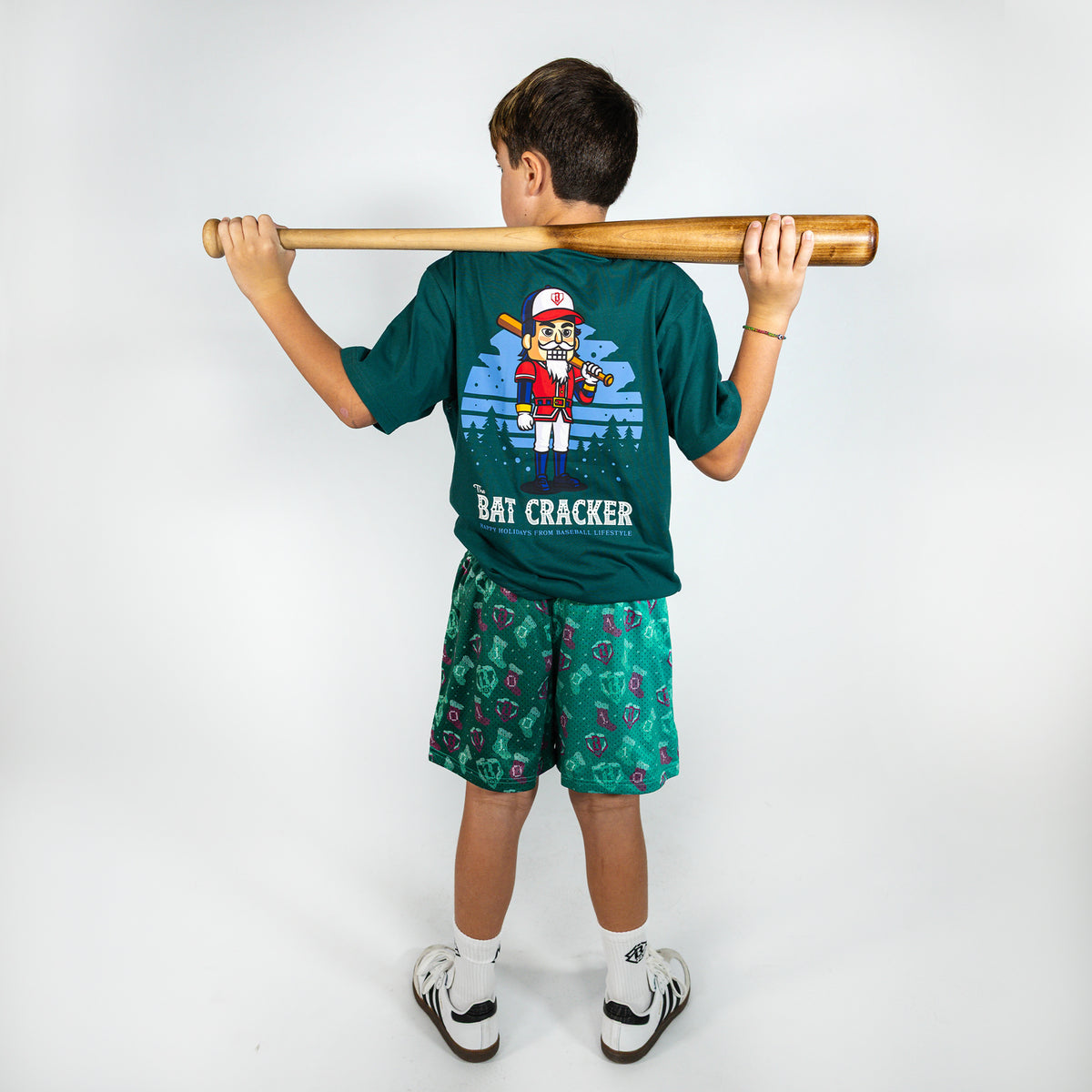 Youth model wearing green Stitched For The SZN youth shorts