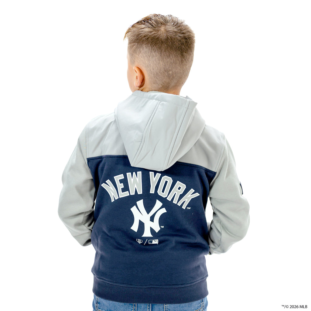 Youth model wearing navy New York Yankees Color Block youth quarter zip