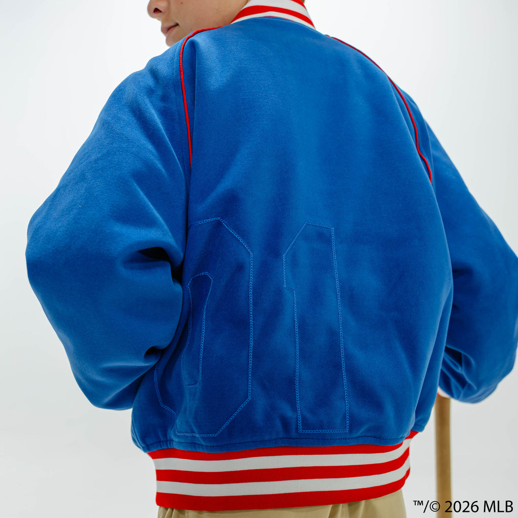 Youth model wearing blue Chicago Cubs Stadium youth bomber jacket