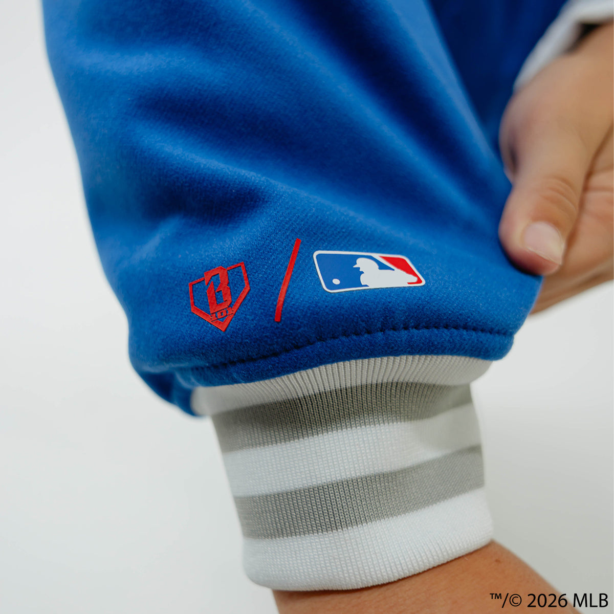 Youth model wearing blue Los Angeles Dodgers Stadium youth bomber jacket