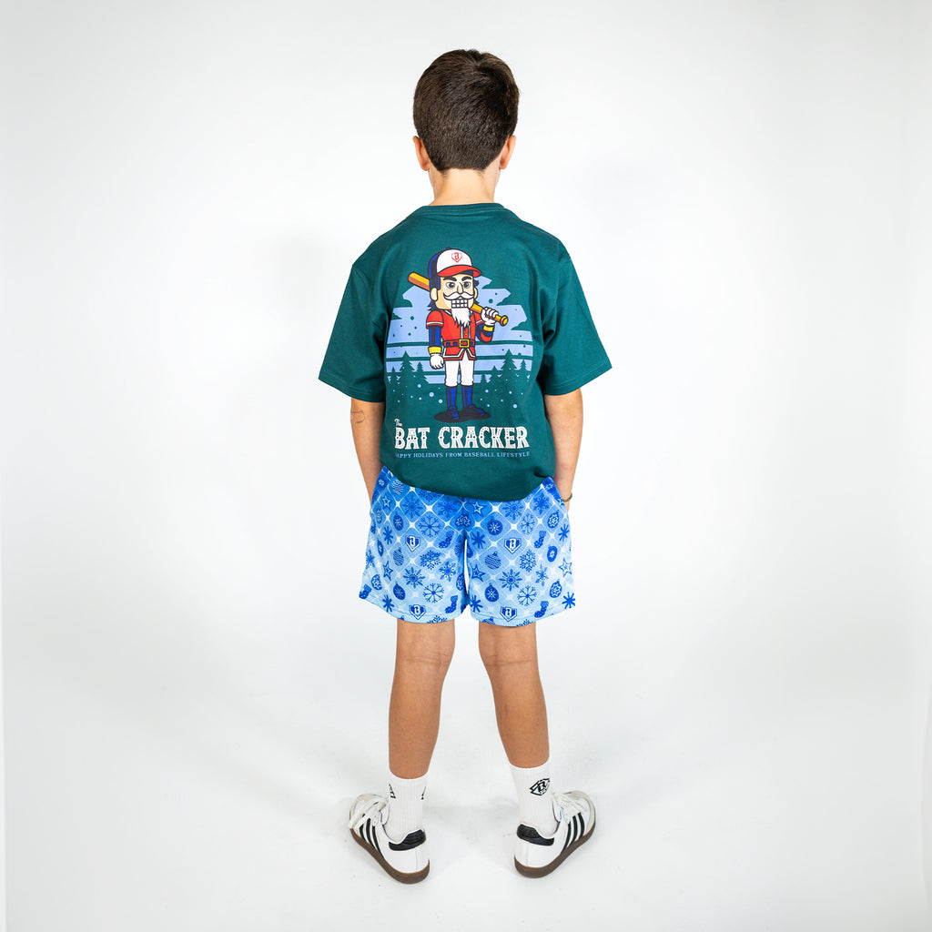 Youth model wearing blue youth shorts with "Frozen Diamond" design