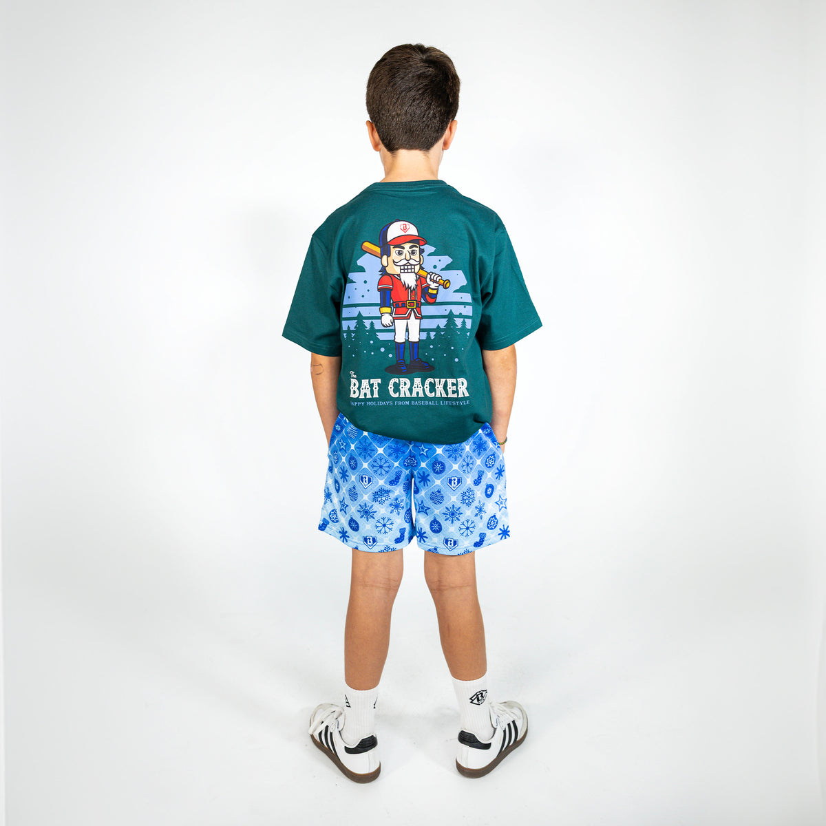 Youth model wearing blue youth shorts with "Frozen Diamond" design